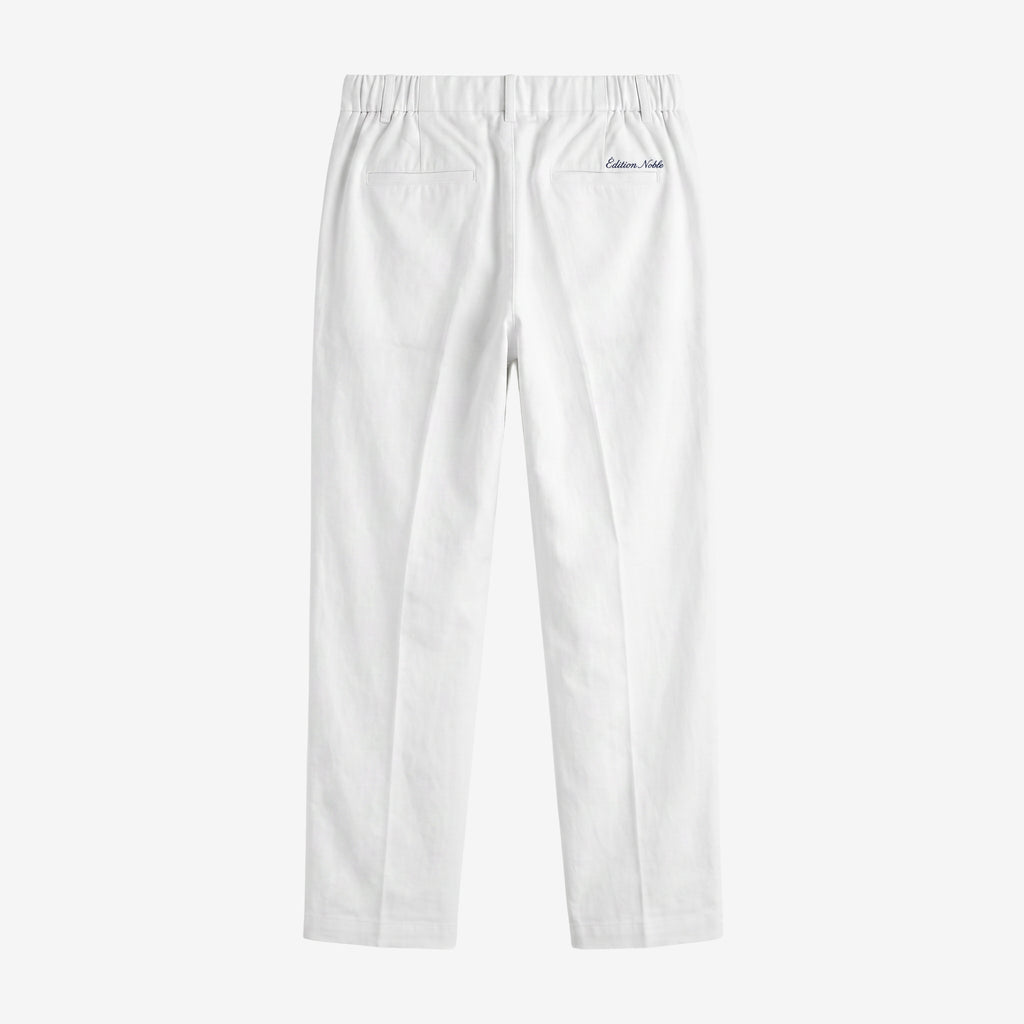 White slim-fit pants shown from the back, featuring an elastic waistband, two back patch pockets, and a small embroidered 'Calvin Klein' logo on the upper right side, set against a plain light gray background.