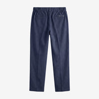 A pair of navy blue trousers shown from the back, featuring an elastic waistband, two back patch pockets, and a small white embroidered logo on the upper right side, set against a plain light gray background.